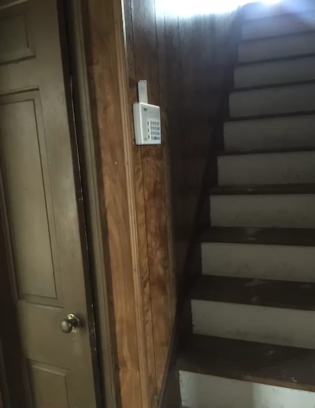 staircase with wooden walls