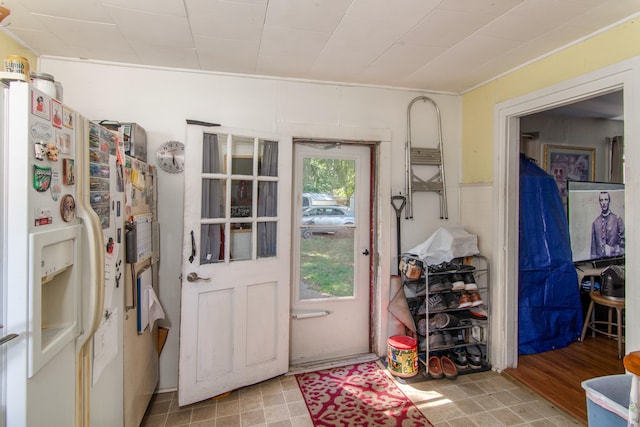 doorway to outside with light hardwood / wood-style floors and ornamental molding