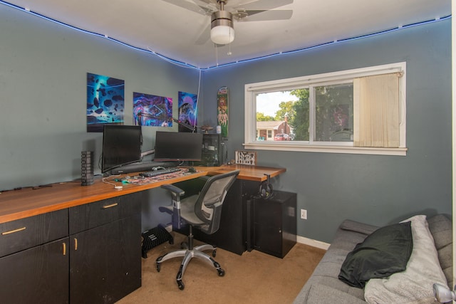 carpeted home office featuring ceiling fan