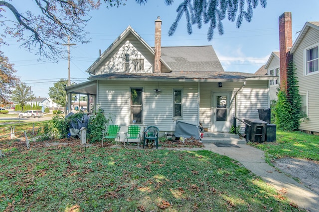 rear view of property featuring a yard