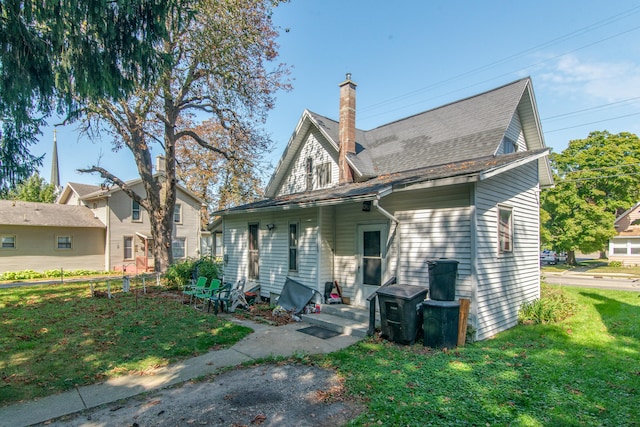 rear view of house with a yard