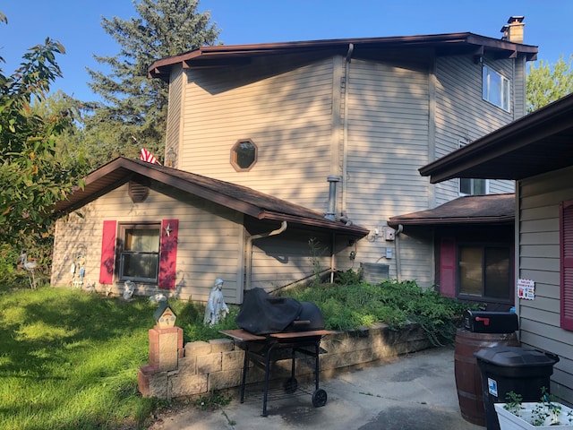 rear view of property with a patio area and a yard