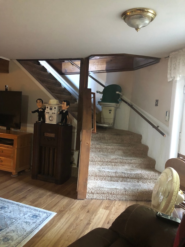 stairs featuring hardwood / wood-style flooring