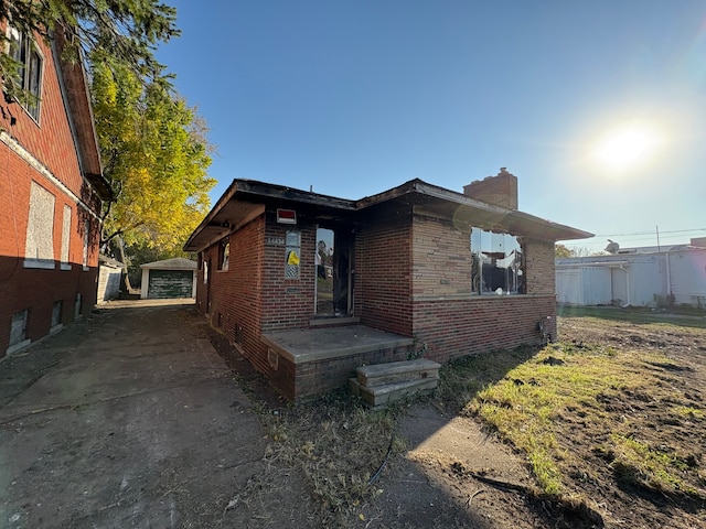 view of front of property with a garage and an outdoor structure