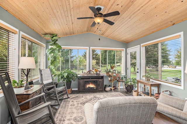 sunroom / solarium featuring ceiling fan, plenty of natural light, wooden ceiling, and vaulted ceiling