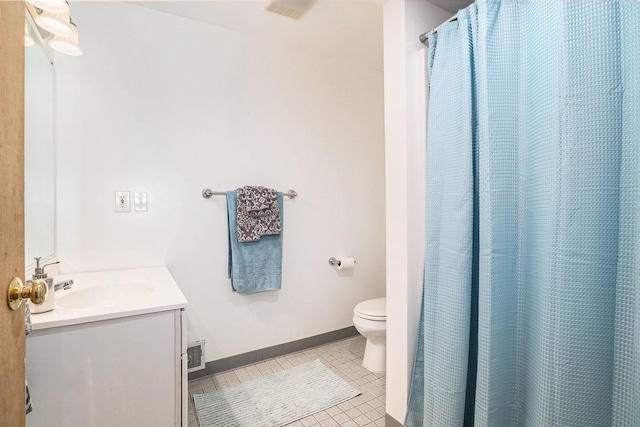 bathroom featuring tile patterned flooring, vanity, and toilet