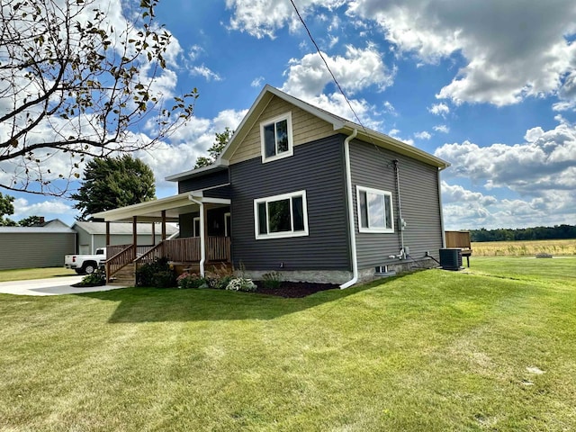 view of front of home featuring cooling unit, covered porch, and a front yard