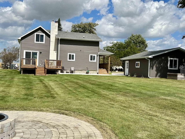 back of house with a patio, a deck, and a lawn