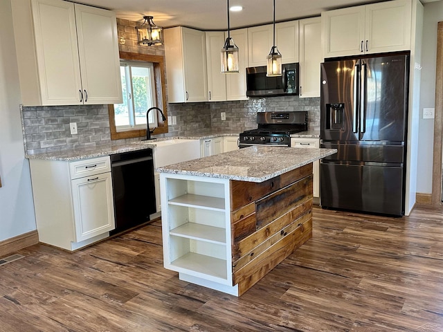 kitchen with light stone countertops, stainless steel appliances, white cabinets, a kitchen island, and hanging light fixtures