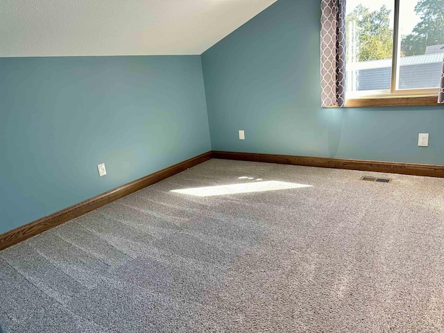 bonus room with carpet flooring and vaulted ceiling