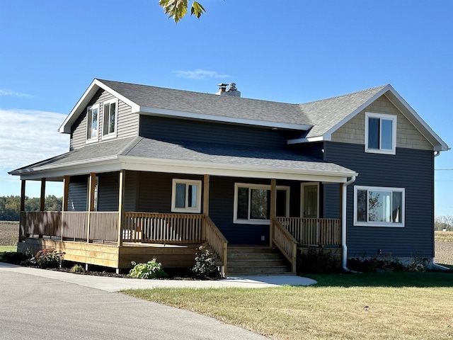 farmhouse inspired home with covered porch and a front yard