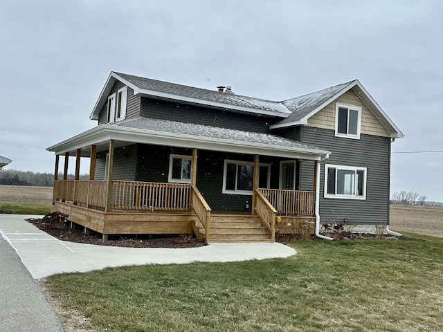 view of front of home with covered porch and a front yard