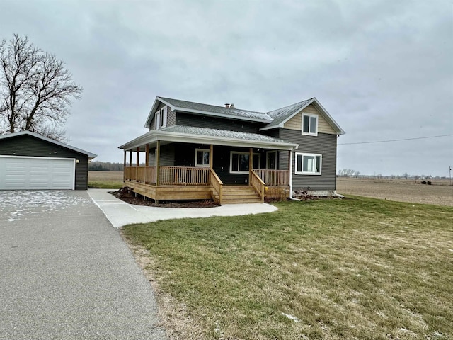 farmhouse inspired home featuring an outbuilding, a porch, a garage, and a front lawn