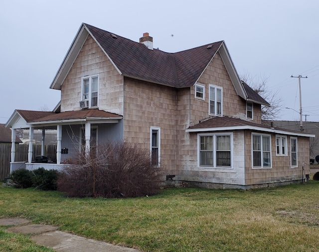 view of side of property featuring a sunroom and a yard