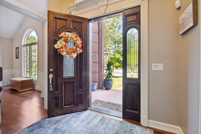 entryway featuring hardwood / wood-style floors and vaulted ceiling