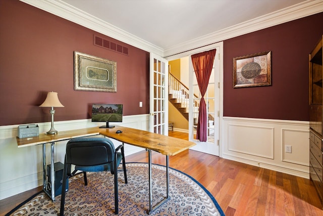 office featuring french doors, hardwood / wood-style flooring, and crown molding