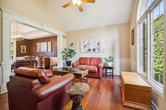 living room featuring wood-type flooring, ceiling fan with notable chandelier, vaulted ceiling, and a healthy amount of sunlight