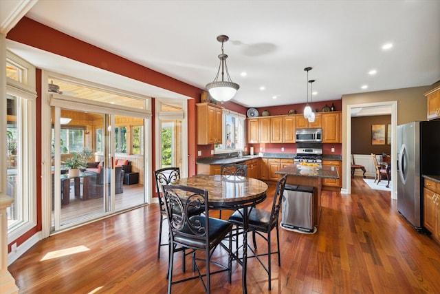 dining space featuring dark hardwood / wood-style flooring and plenty of natural light