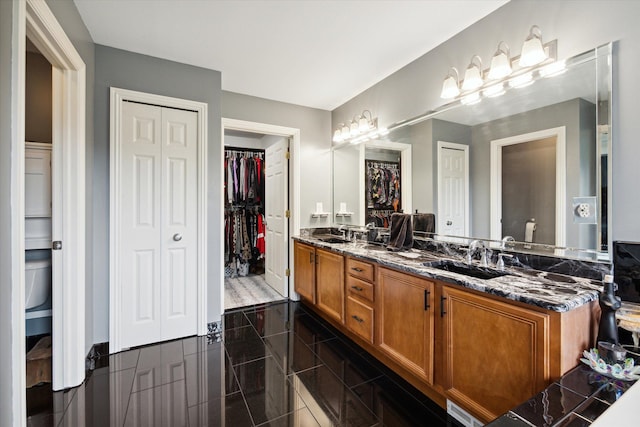 bathroom with tile patterned flooring, vanity, and toilet