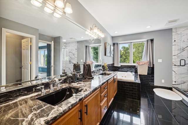 bathroom featuring plus walk in shower, tile patterned flooring, and vanity