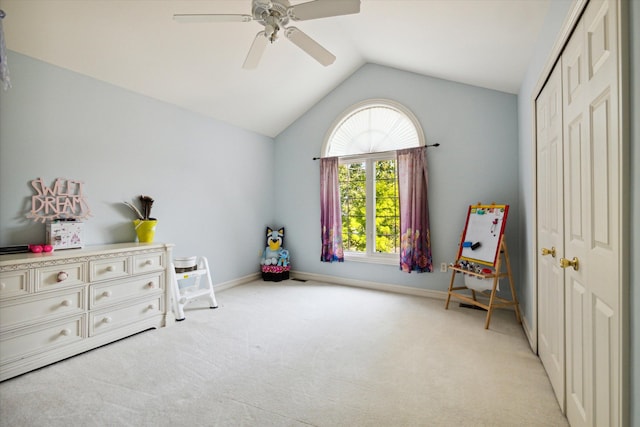 playroom featuring ceiling fan, light colored carpet, and vaulted ceiling