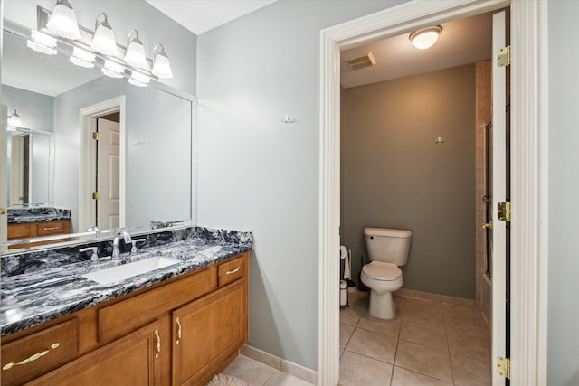 bathroom featuring toilet, vanity, and tile patterned floors