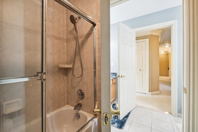 bathroom with tile patterned floors, combined bath / shower with glass door, and ornamental molding