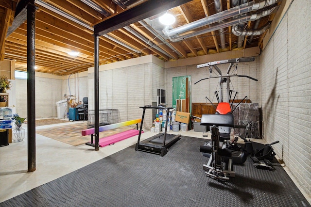 exercise room featuring brick wall