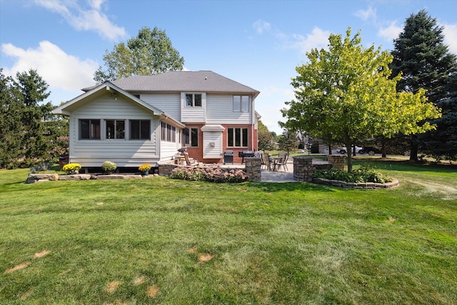 back of house with a yard and a patio