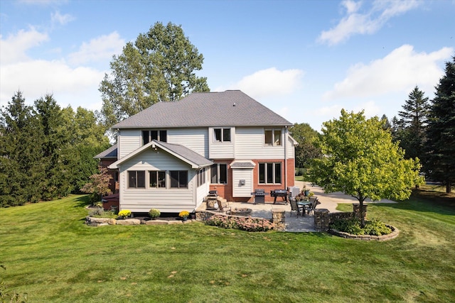 rear view of house with a lawn and a patio area