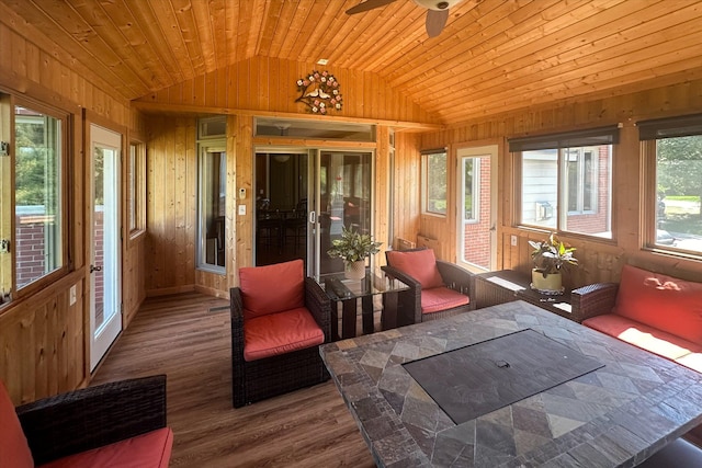 sunroom / solarium with ceiling fan, vaulted ceiling, plenty of natural light, and wood ceiling