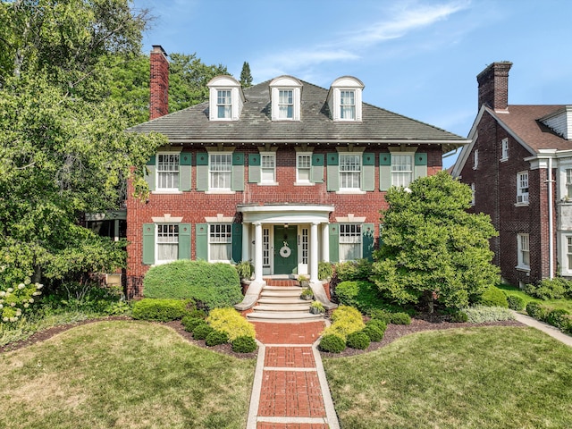 colonial home with a front lawn