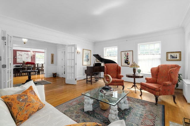 living room with a healthy amount of sunlight, wood-type flooring, and french doors