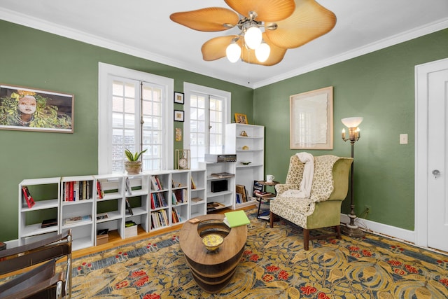 sitting room featuring ceiling fan and crown molding