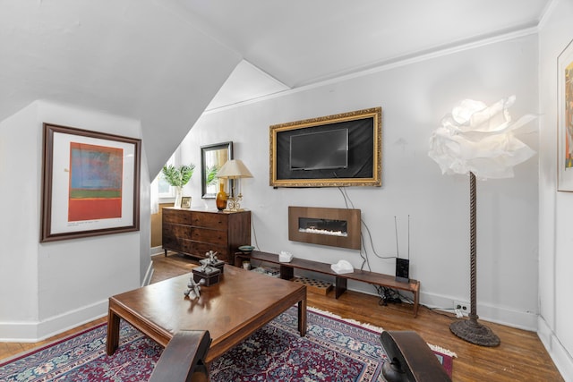 sitting room with hardwood / wood-style floors and vaulted ceiling