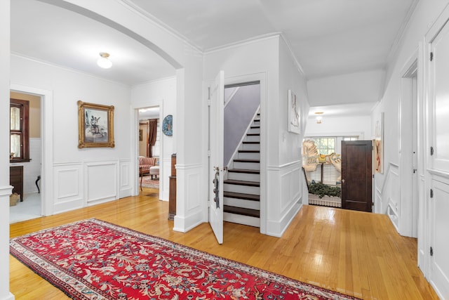 foyer with hardwood / wood-style flooring and ornamental molding