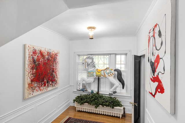 mudroom featuring wood-type flooring and crown molding