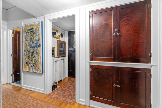 corridor with light hardwood / wood-style flooring