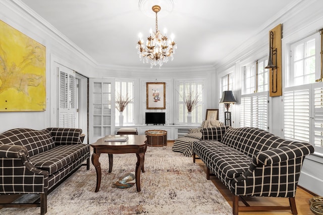 sitting room featuring crown molding, plenty of natural light, and a notable chandelier