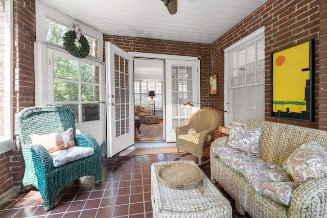 sunroom featuring ceiling fan