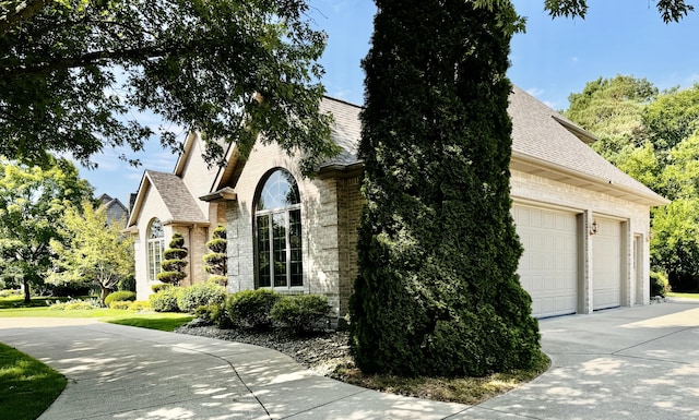 view of side of home featuring a garage