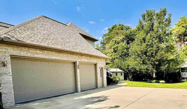 view of side of home featuring a yard and a garage