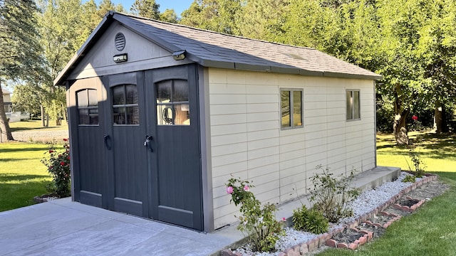 view of outbuilding with a yard