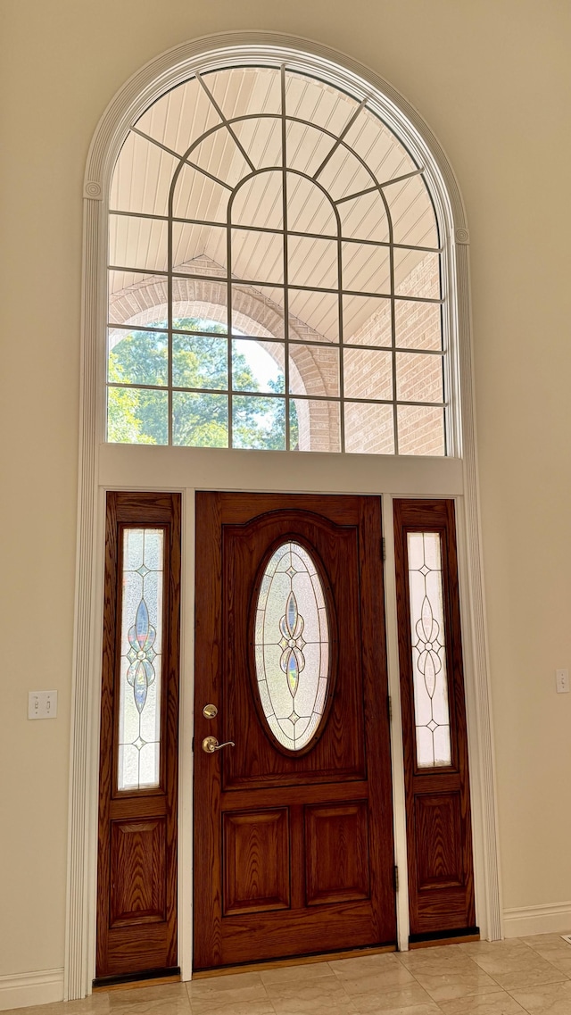 entryway with light tile patterned flooring