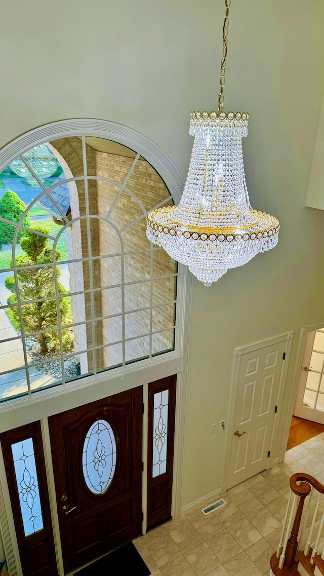 entrance foyer with a high ceiling and a chandelier