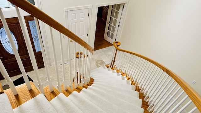 staircase with hardwood / wood-style flooring