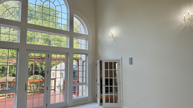 entryway with a towering ceiling and a wealth of natural light