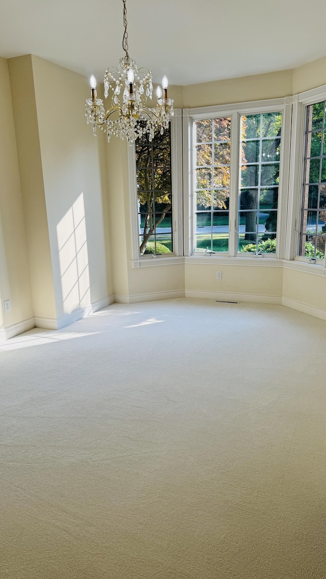 unfurnished dining area with carpet flooring and a notable chandelier