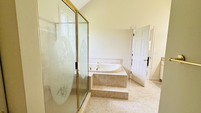 bathroom with tile patterned floors, shower with separate bathtub, and vaulted ceiling