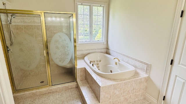 bathroom with tile patterned flooring and separate shower and tub